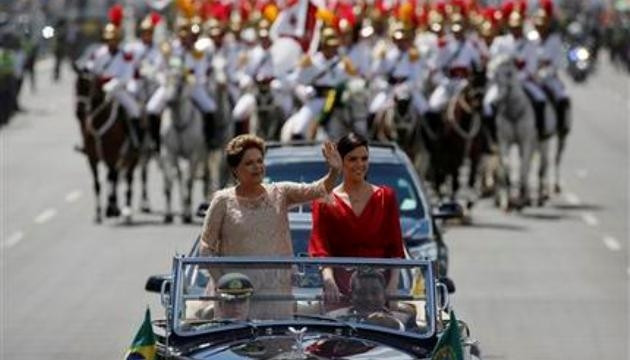 Tổng thống Brazil Dilma Rousseff (bên trái) cùng con gái Paula Rousseff Araujo vẫy tay chào người dân trên đường tới Quốc hội, nơi diễn ra lễ tuyên thệ nhậm chức của bà Rousseff, ngày 1-1-2015. (Ảnh: 