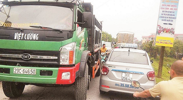 Để né trạm thu phí trên đường cao tốc Hà Nội - Bắc Giang, nhiều ô-tô đi vào đường đê Phù Đổng (Gia Lâm), gây tắc đường.