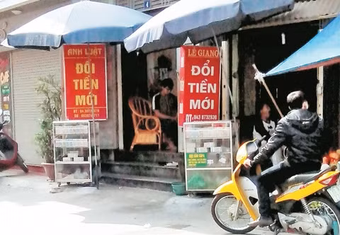 Các quầy đổi tiền hoạt động công khai tại lối vào đền Ghềnh, phố Phú Viên, phường Bồ Đề, quận Long Biên.