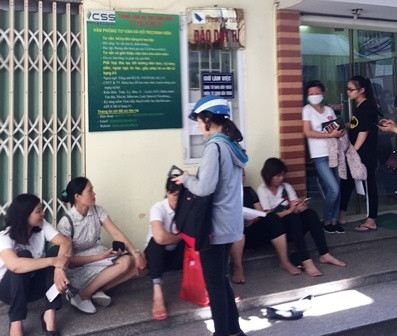 Phụ huynh ngồi chờ trước một điểm tuyển sinh của Trường THPT Đào Duy Từ sáng 29-6 (Ảnh: THÙY LINH)