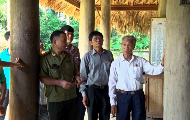 Ông Viên Đức Minh (người bên phải) giới thiệu với khách tham quan về truyền thống lịch sử đình Hồng Thái.