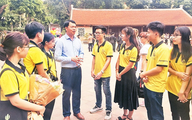 Các tình nguyện viên hướng dẫn khách du lịch tại Văn Miếu - Quốc Tử Giám, đây là nét văn hóa ứng xử đẹp ở Hà Nội.