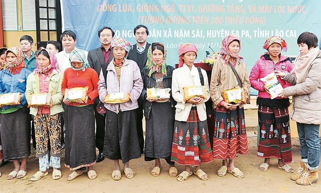 Đại diện Ngân hàng  LienVietpostBank, Quỹ tấm lòng Việt trao giống lúa, ngô cho người dân xã Nậm Sài, huyện Sa Pa, Lào Cai. Ảnh: Hải Thanh