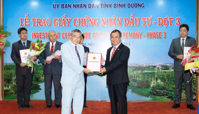 Chủ tịch UBND tỉnh Bình Dương Trần Văn Nam (bên phải) trao Giấy chứng nhận đầu tư cho doanh nghiệp FDI.