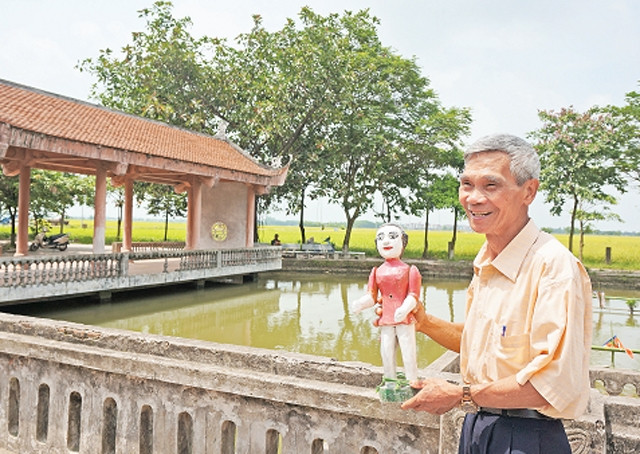 Anh hùng - nghệ nhân Đinh Thế Văn giới thiệu nghệ thuật rối nước.