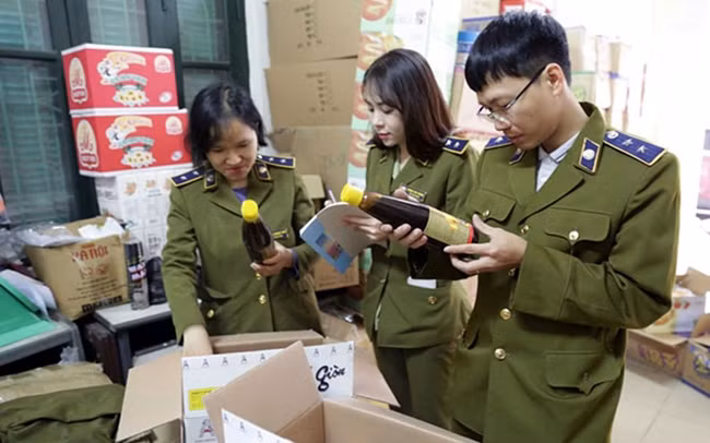 Cán bộ Đội Quản lý thị trường số 5 (Cục Quản lý thị trường Hà Nội) kiểm tra, thu giữ số hàng hóa không có chứng nhận xuất xứ. Ảnh: TRẦN VIỆT