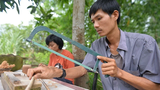 Trần Minh Tiến đang làm ống hút từ tre.