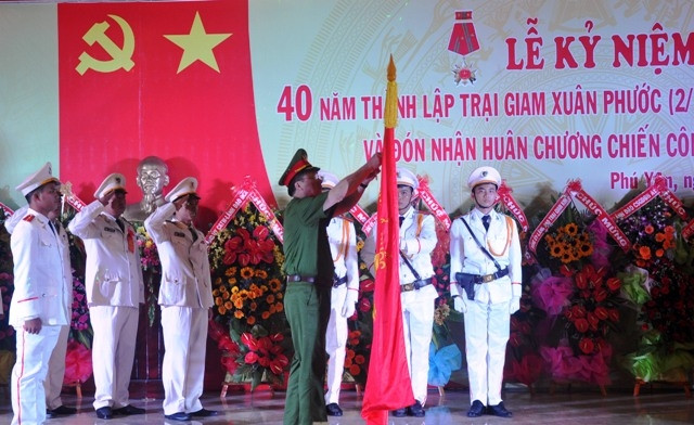 Thượng tướng Nguyễn Văn Thành gắn Huân chương Chiến công hạng nhì do Chủ tịch nước trao tặng Trại giam Xuân Phước lên lá cờ Bảo vệ an ninh Tổ quốc của đơn vị.