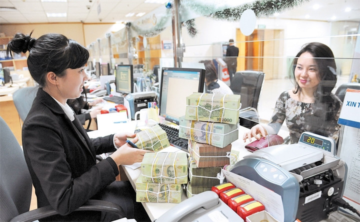 Năm 2014, thị trường tài chính - tiền tệ ổn định, lãi suất có xu hướng giảm, tín dụng tăng khá. Ảnh | Trần Hải