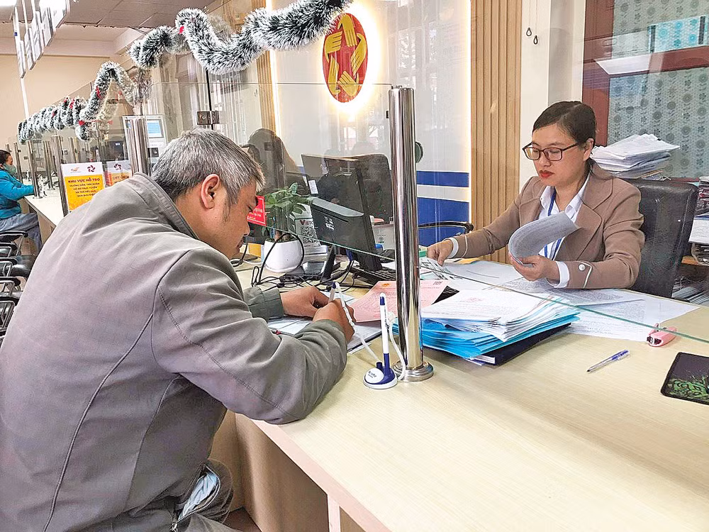 Cán bộ Trung tâm phục vụ hành chính công phường Lang Biang - Đà Lạt làm thủ tục hành chính phục vụ người dân.