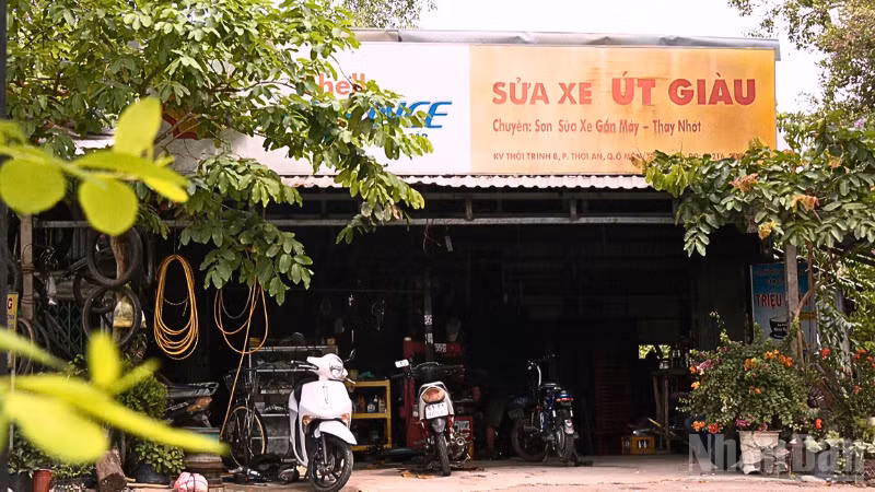 Tiệm sửa xe của ông Giàu nằm lọt thỏm giữa những tán cây ven đường.