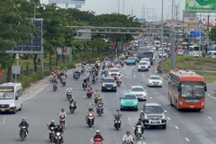 Người tham gia giao thông lưu thông trên đường Phạm Văn Đồng.