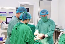 Bác sĩ phẫu thuật lấy thai cho sản phụ. 
