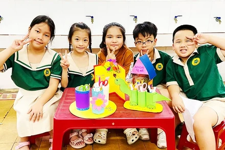 Học sinh Trường tiểu học Lê Lợi (TP Huế) bên các sản phẩm tái chế từ đồ đã qua sử dụng.
