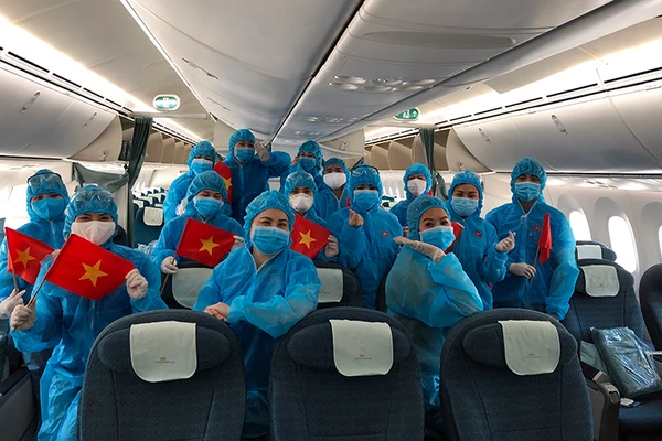Tổ bay Vietnam Airlines trước khi khởi hành chuyến bay hồi hương cho công dân Anh từ Việt Nam và cho công dân Việt Nam từ Anh về nước. Nguồn: VNA