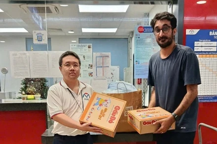 Người nước ngoài mang hàng cứu trợ người dân vùng lũ đến ga Metro kết hợp di chuyển bằng Metro. (Ảnh: VÕ LÊ)