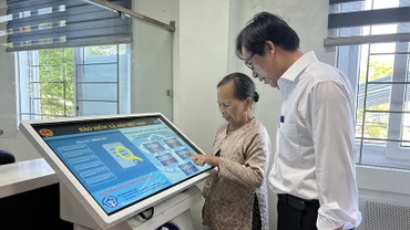 Cán bộ Bảo hiểm xã hội thành phố Hội An, tỉnh Quảng Nam hướng dẫn người dân làm thủ tục bảo hiểm xã hội.