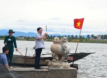 Chủ tịch Quốc hội Vương Đình Huệ thực hiện nghi lễ thả hoa tưởng niệm các anh hùng liệt sĩ trên dòng sông Thạch Hãn. (Ảnh Duy Linh)