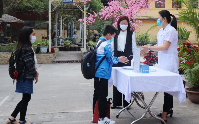 Giáo viên Trường tiểu học Ngô Sĩ Liên (TP Bắc Giang) hướng dẫn học sinh sát khuẩn tay trước khi vào lớp. (Ảnh: Lệ Thanh)