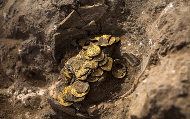 Những đồng tiền vàng cổ trong chiếc bình. Ảnh: USA Today