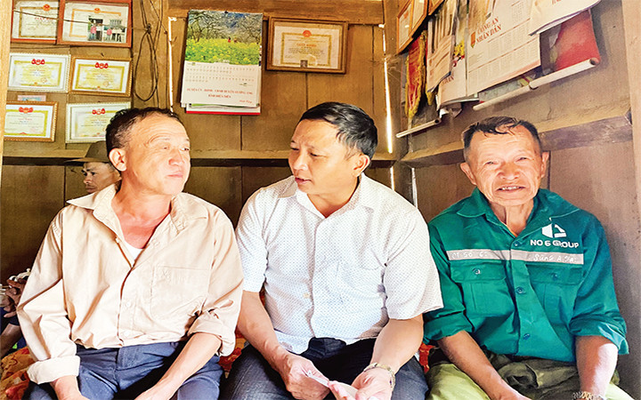 Anh Hờ Ngọc Sếnh (giữa) ân cần hỏi thăm người dân. Ảnh: THỦY LÊ