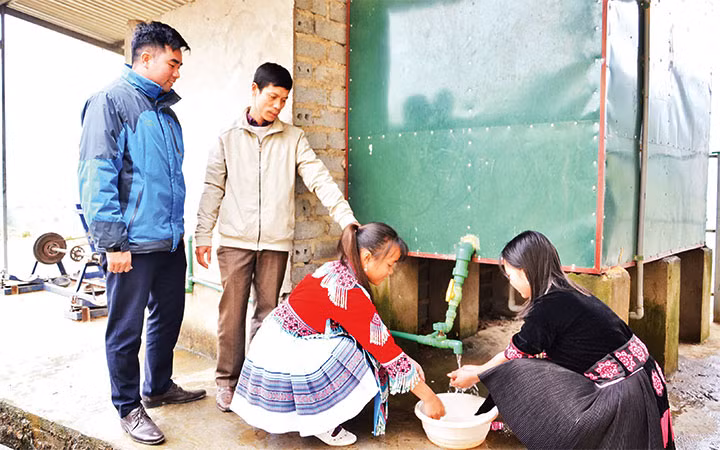 Thầy giáo Vũ Xuân Quế bên hệ thống bếp đun nước nóng bằng công nghệ ủ trấu, giúp hàng trăm học sinh Trường THCS và THPT Bát Xát có nước nóng sử dụng trong mùa đông giá rét.