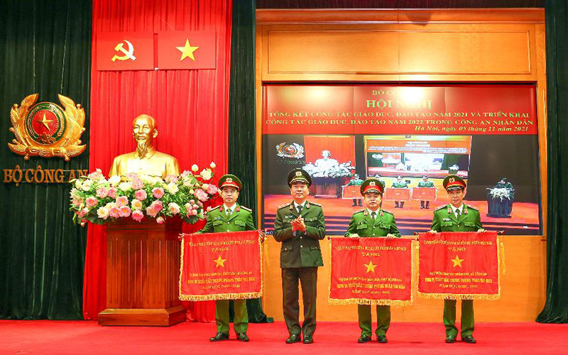 Thứ trưởng Công an Trần Quốc Tỏ thừa ủy quyền của Thủ tướng Chính phủ, tặng Cờ Thi đua xuất sắc của Chính phủ cho các học viện, trường Công an nhân dân tại Hội nghị Tổng kết công tác giáo dục, đào tạo năm 2021 và triển khai công tác giáo dục, đào tạo năm 2022 trong Công an nhân dân.