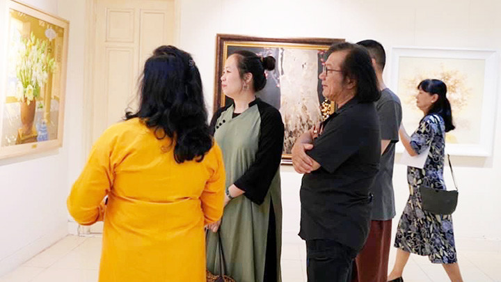 Khách tham quan triển lãm tranh “Hà Nội những sắc hoa” và “Quốc hoa các nước thành viên ASEAN”.