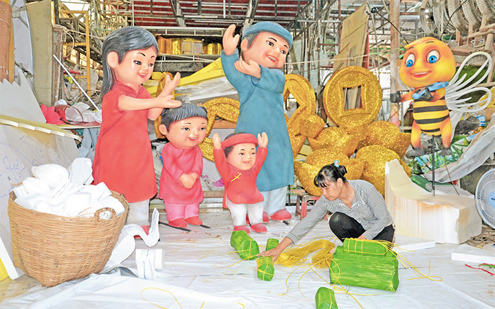 Nhân viên Công ty Mỹ thuật Văn Tòng đang khẩn trương hoàn thành các công việc để kịp tiến độ thi công Đường hoa Nguyễn Huệ Tết Nguyên đán Tân Sửu.