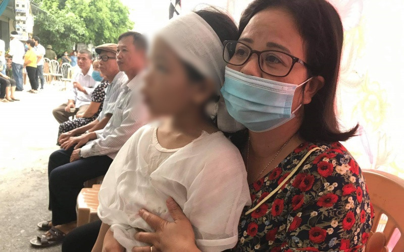 Chị Lương Thị Kiều Oanh, Chủ tịch Hội LHPN huyện Kiến Xương (tỉnh Thái Bình) bên cháu bé 6 tuổi (con nạn nhân Hương).