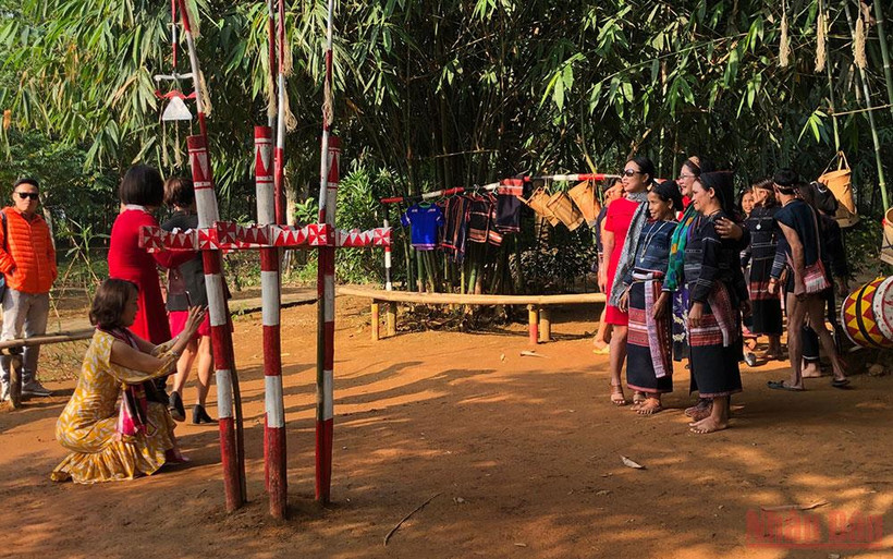 Du khách chụp ảnh với đồng bào dân tộc tại Làng Văn hóa.