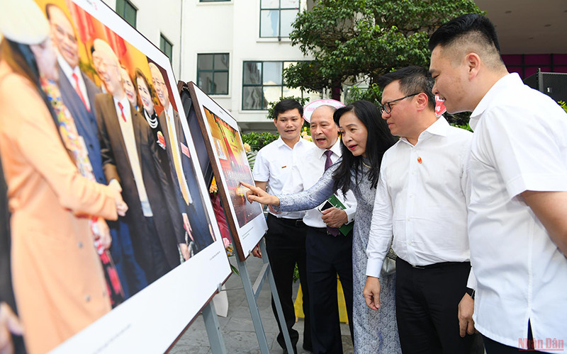 Tổng Biên tập Báo Nhân Dân Lê Quốc Minh cùng các đại biểu tham quan triển lãm. Ảnh: THÀNH ĐẠT