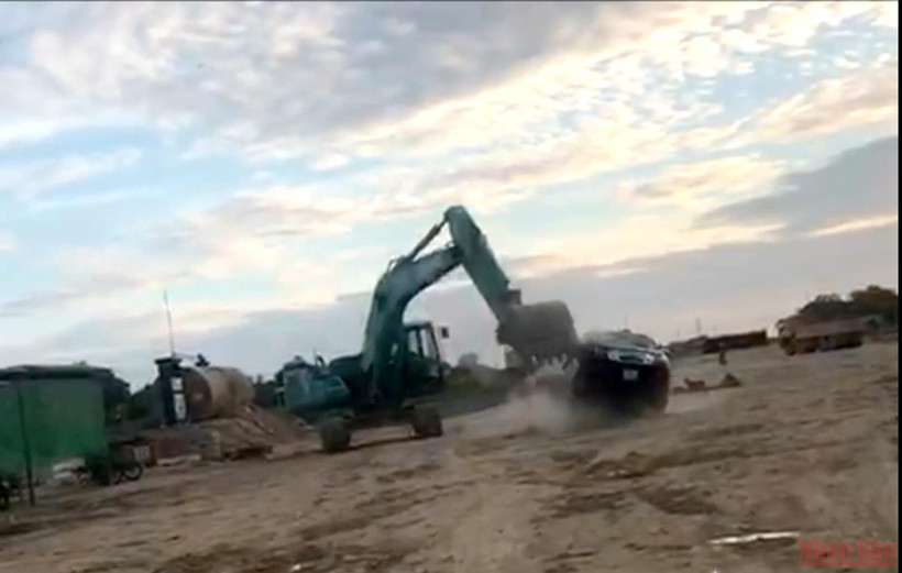 Lái xe múc Đinh Văn Hoàng điều khiển gàu múc bổ nát chiếc xe bán tải. (ẢNH CẮT TỪ CLIP)