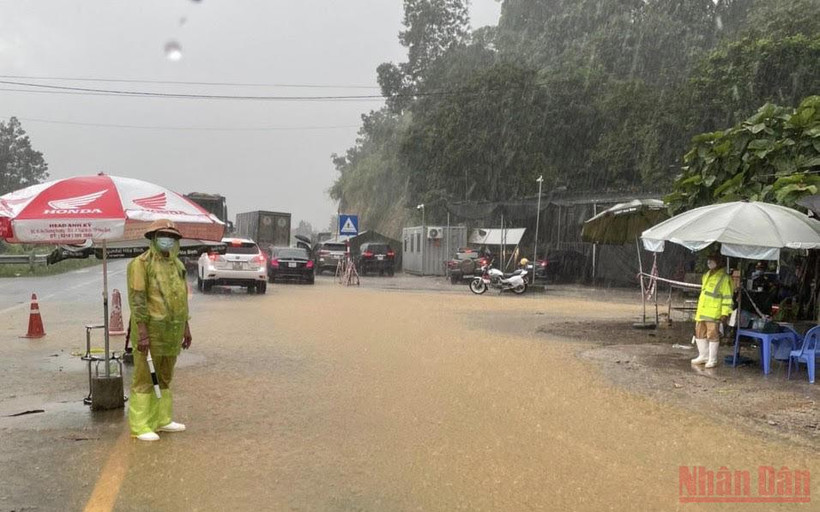 Lực lượng chức năng làm nhiệm vụ tại chốt kiểm soát dịch. (Ảnh: TRẦN HẢO)