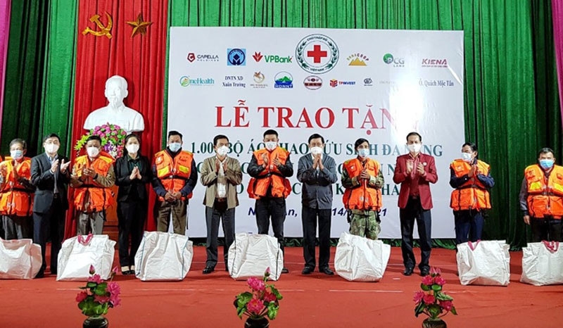 Nguyên Chủ tịch nước Trương Tấn Sang cùng lãnh đạo Trung ương Hội Chữ thập đỏ Việt Nam, tỉnh Nghệ An và nhà tài trợ trao tặng áo phao cho ngư dân Cửa Lò. 