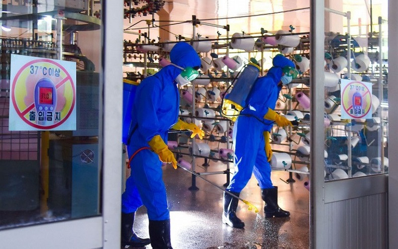 Phun khử khuẩn nhà xưởng sản xuất ở Triều Tiên. (Ảnh: KCNA)