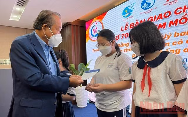 Đồng chí Trương Hòa Bình, nguyên Ủy viên Bộ Chính trị, nguyên Phó Thủ tướng thường trực Chính phủ trao quà cho các em học sinh khó khăn do ảnh hưởng của dịch Covid-19.