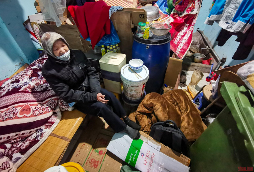Bà Thìn dùng bìa các-tông làm chiếu rải dưới đất trong những ngày giá rét lịch sử. (ẢNH: THÀNH ĐẠT)