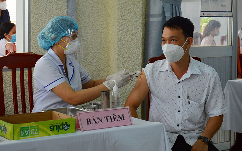 Tiêm liều vaccine nhắc lại cho đối tượng theo quy định tại Trung tâm Kiểm soát bệnh tật tỉnh Đồng Tháp. (Ảnh: TTXVN)