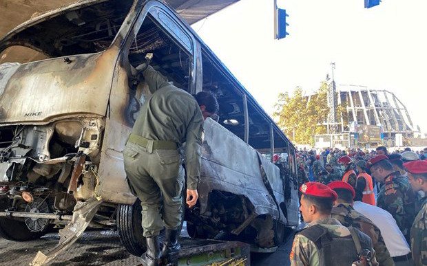 Lực lượng an ninh kiểm tra hiện trường vụ đánh bom nhằm vào xe buýt quân sự ở trung tâm Damascus (Syria) ngày 20/10/2021. (Nguồn: Reuters)