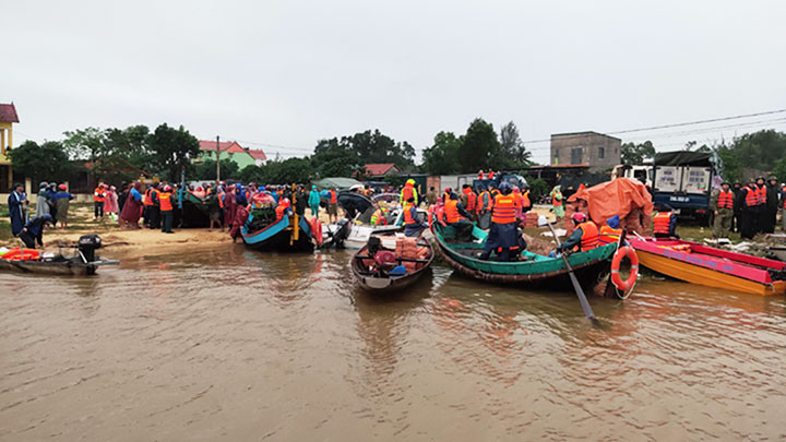 Ngư dân xã Ngư Thủy dùng thuyền đi biển để cứu trợ khẩn cấp người dân vùng lũ Lệ Thủy.