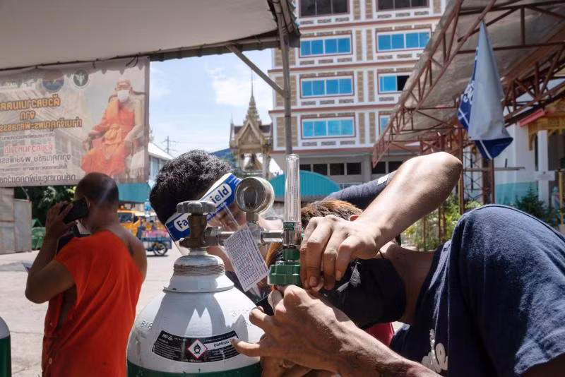 Các tình nguyện viên chuẩn bị bình ô-xy cho bệnh nhân Covid-19 tại một bệnh viện ở thủ đô Bangkok. (Ảnh: Bloomberg)