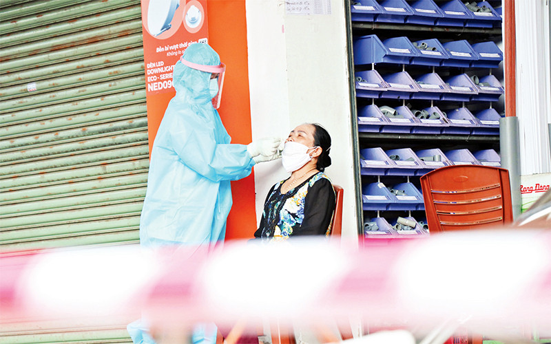Lấy mẫu xét nghiệm cho người dân tại khu phong tỏa ở phường Tân Thành, TP Buôn Ma Thuột (Ðắk Lắk). Ảnh: TUẤN ANH 