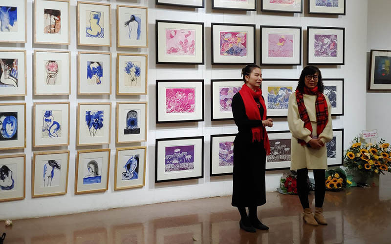 Hai nữ họa sĩ Trang Thanh Hiền và Nguyễn Mỹ Ngọc giới thiệu các tác phẩm tại triển lãm “Mùa trong vườn”. (Ảnh: Thế Sơn)