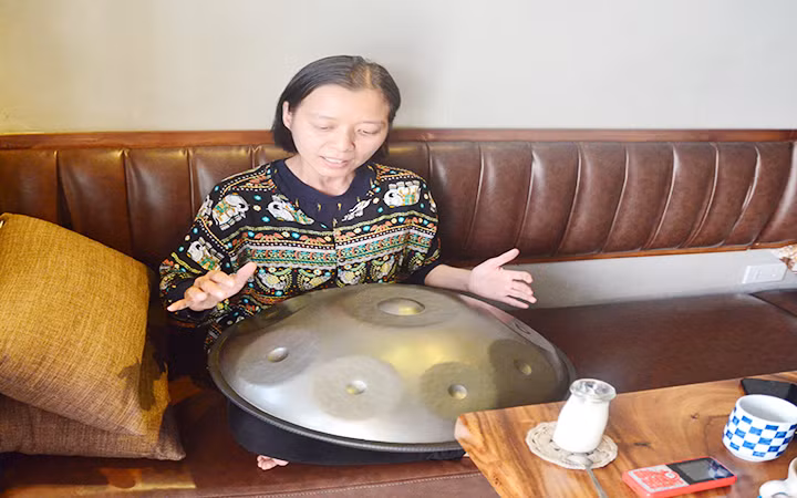 Chị Nguyễn Thị Ngọc Hiếu vừa đệm trống vừa hát.