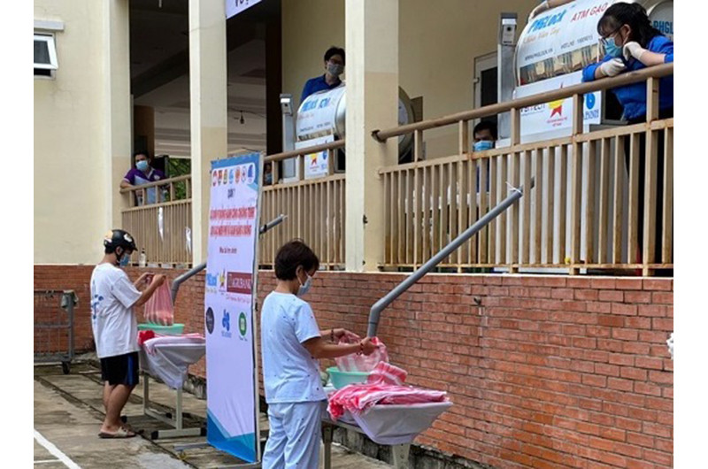Người dân lấy gạo từ ATM gạo miễn phí đặt tại quận 7.