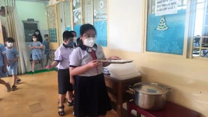 Học sinh Thành phố Hồ Chí Minh trong giờ ăn bán trú. (Ảnh minh họa)