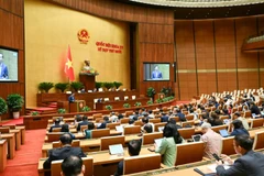 Quốc hội làm việc tại hội trường, nghe Tờ trình và Báo cáo thẩm tra dự án Luật sửa đổi, bổ sung một số điều của Luật Quản lý nợ công. (Ảnh: DUY LINH)