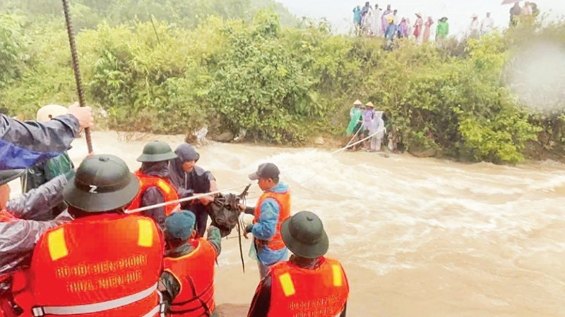 Đồn Biên phòng Cửa khẩu Hồng Vân (thành phố Huế) cùng các lực lượng công an, quân sự, dân quân địa phương tổ chức cứu trợ người dân thôn Ta Lo A Hố (xã Hồng Vân trước đây) bị cô lập, chia cắt trong mưa lũ. (Ảnh: CÔNG HẬU)