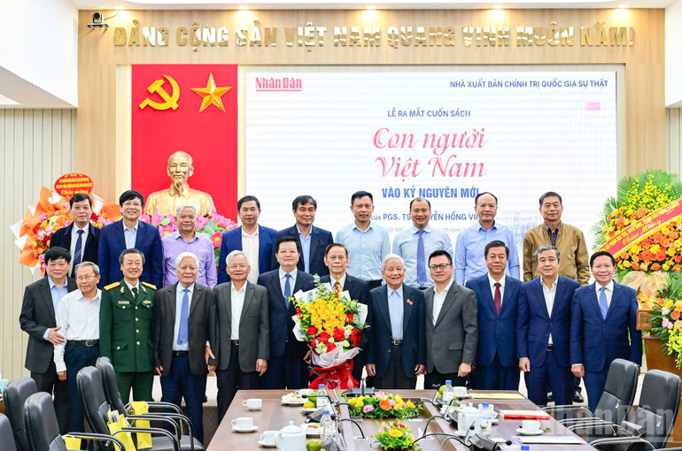 Các đại biểu chụp ảnh lưu niệm cùng tác giả Nguyễn Hồng Vinh tại Lễ ra mắt sách. (Ảnh: BẢO LONG) ndo_br_8e61e20f4680cbde92911.jpg